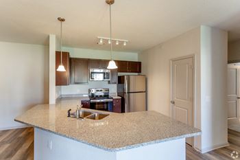 a kitchen with granite countertops and stainless steel appliances at The Venue at 109 Apartments , Tennessee